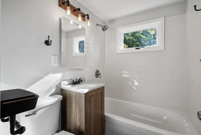 Bathroom with subway tile tub surround and wood vanity, Twin Cities