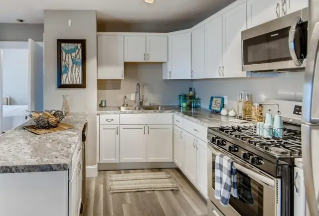 L-shaped white shaker kitchen with gas range, St. Paul, MN